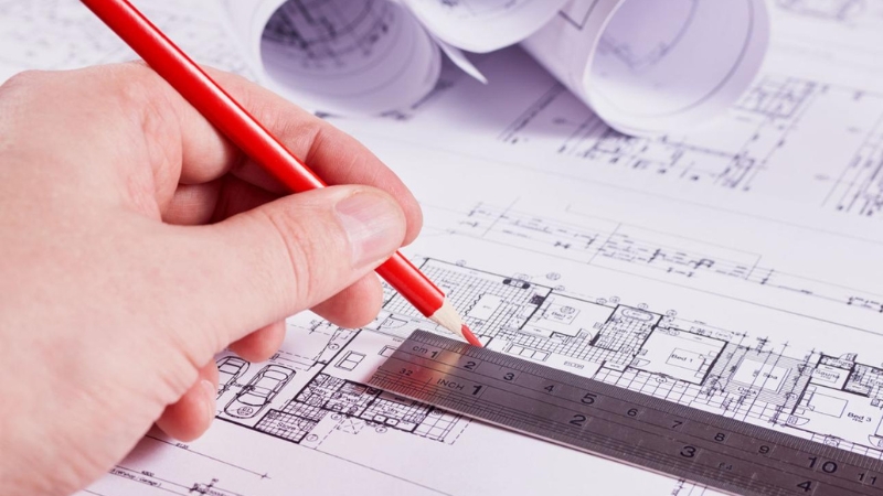 engineer updating site plans to respond to red markups and permit correction comments