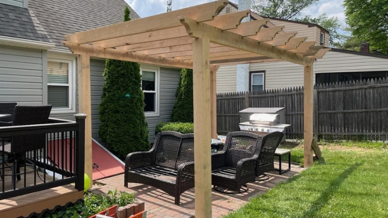 Contractor and engineer reviewing covered deck and pergola construction plans