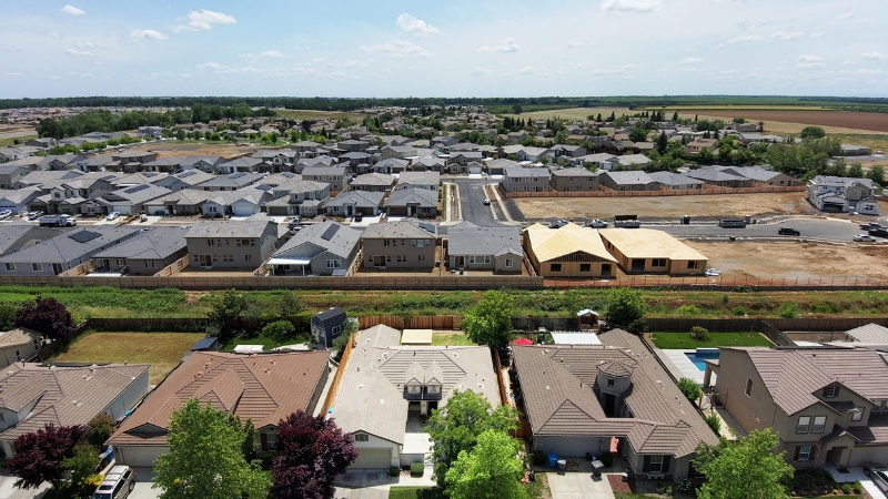 An aerial drone view of a newly designed residential housing subdivision layout with divided land parcels.