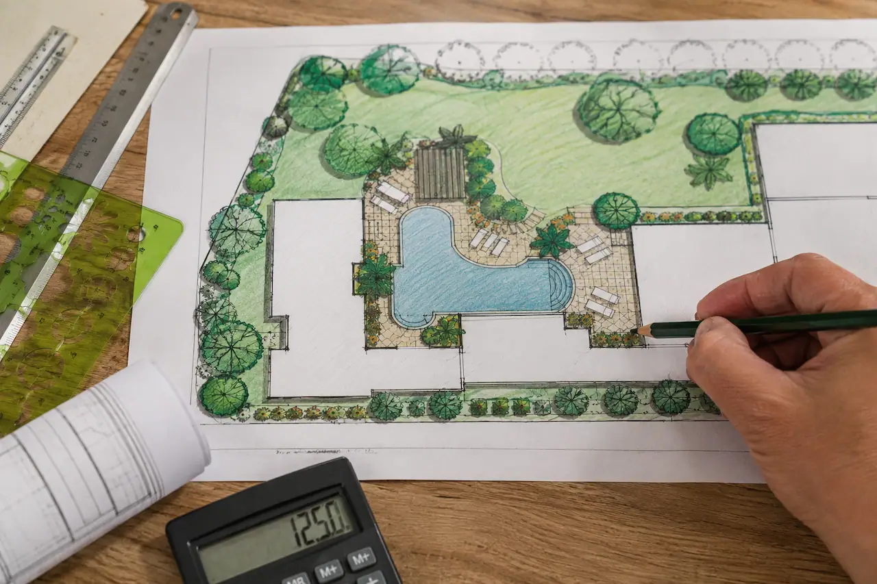 Residential site plan drawing for a Lakeland, Florida permit showing a home layout, landscaping, swimming pool, and property improvements being reviewed by a designer.
